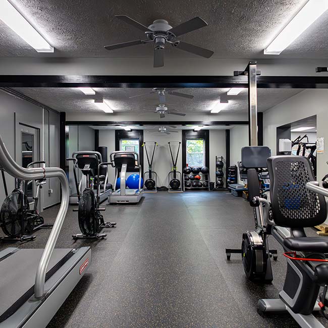 Modern gym with treadmills, bikes, and weights; Fitness Center Memberships in Pittsburgh available.