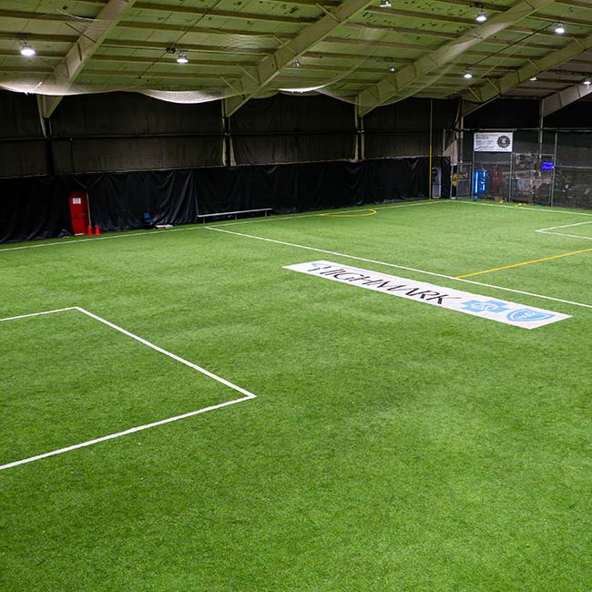 Indoor Field & Court Rentals in Pittsburgh: artificial turf soccer field with white markings.